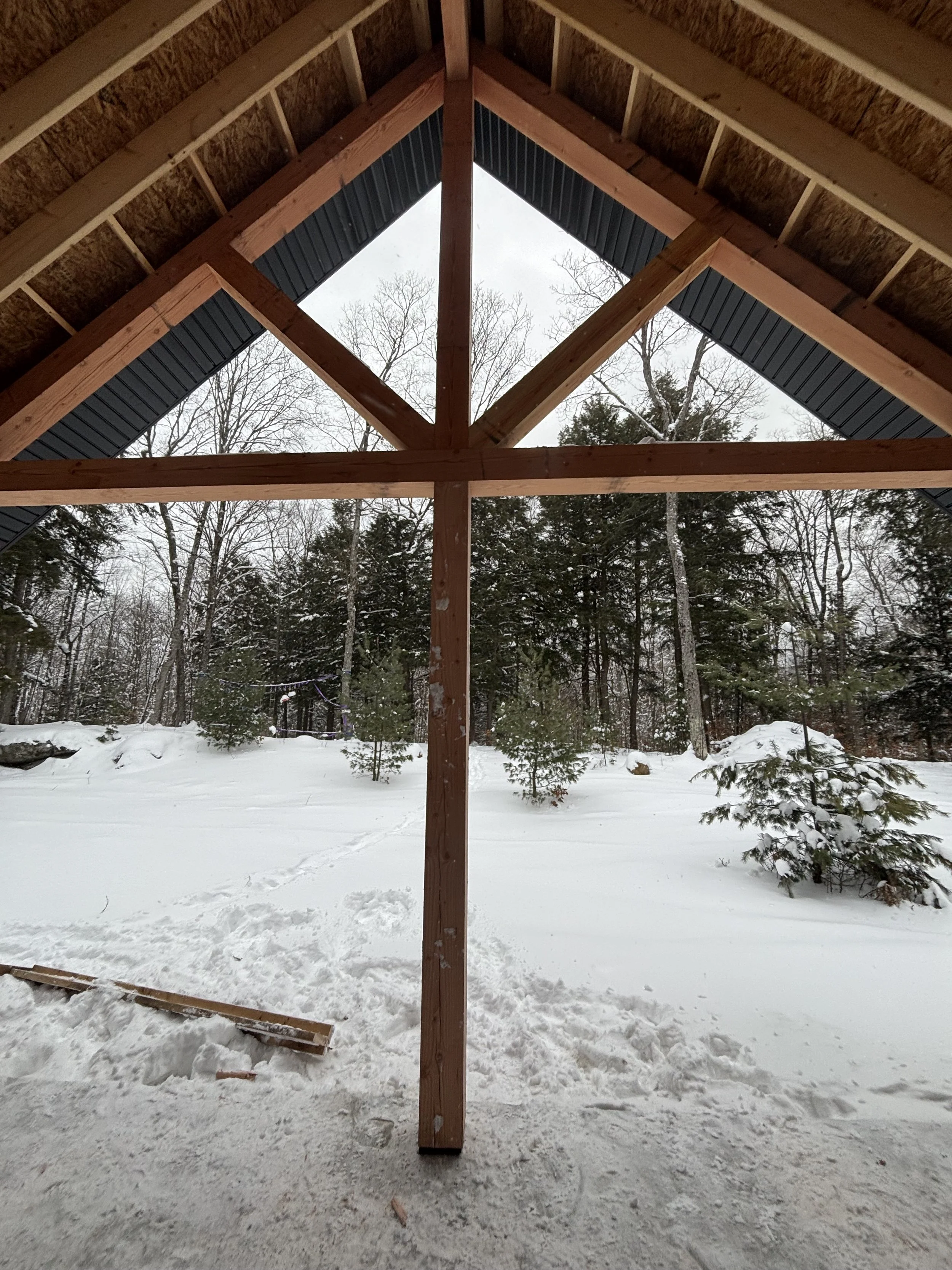 Timber-framed Muskoka build by Pinard Construction in winter